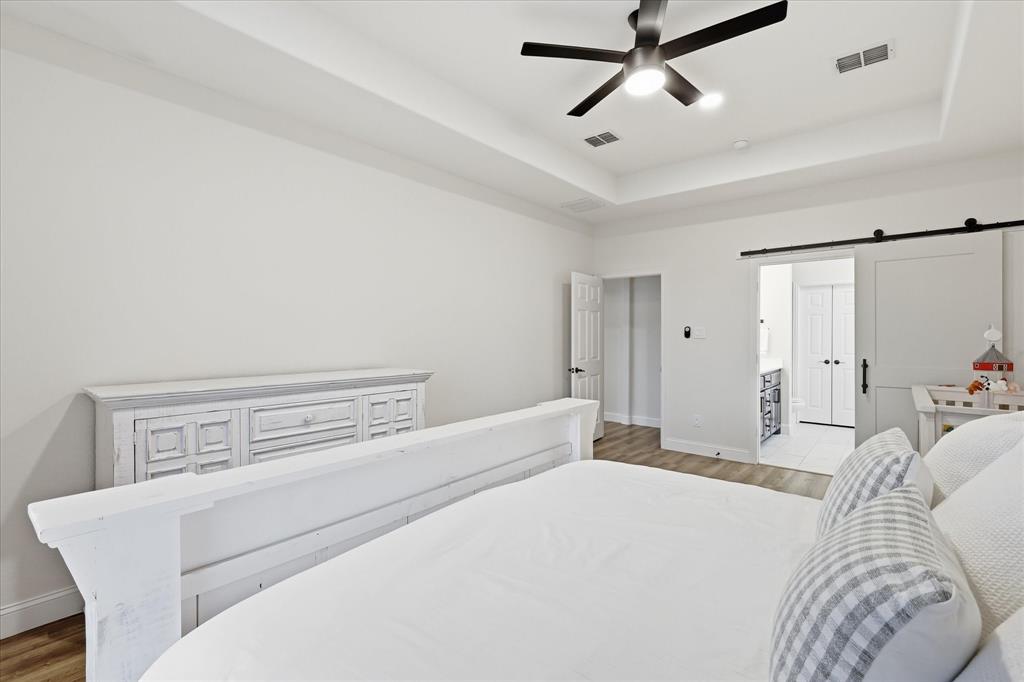 430 Ridgecrest Place Sanger, TX 76266 - Photo 14 of 40 Primary Bedroom- Tray ceiling with recessed lighting and a ceiling fan