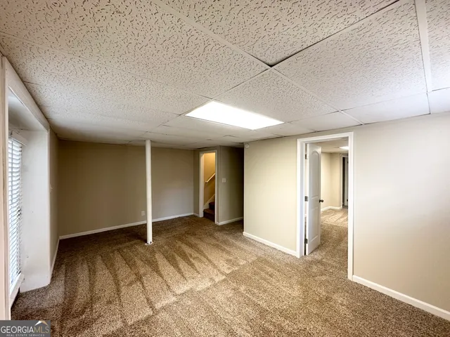an empty room with closet and windows