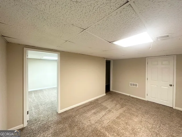 a view of a house with a yard and garage