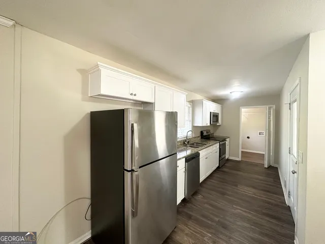 a kitchen with stainless steel appliances a refrigerator and a stove
