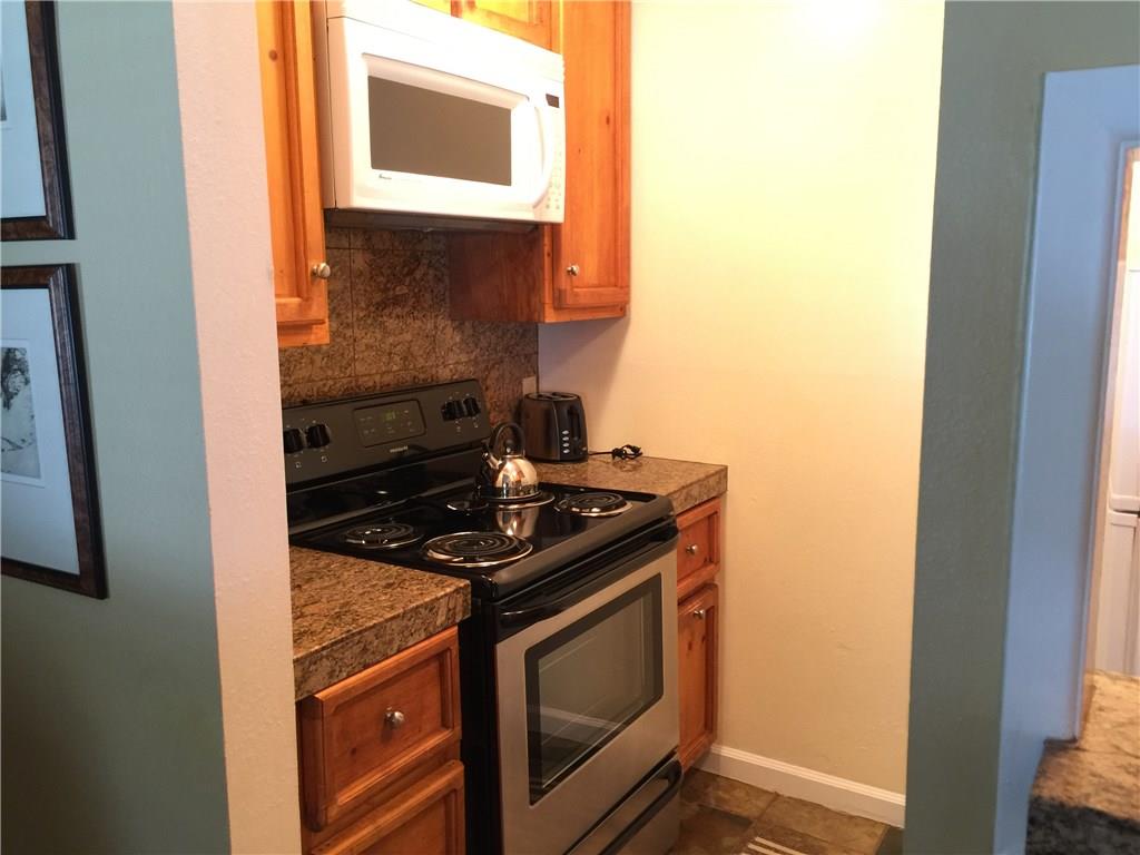 1977 Soda Ridge Road, Unit 1171 Keystone, CO 80435 - Photo 9 of 21 a kitchen with a stove and a microwave