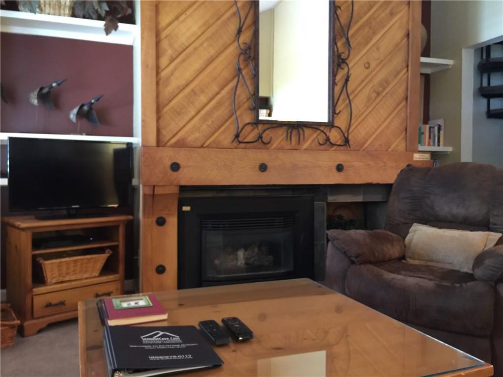 1977 Soda Ridge Road, Unit 1171 Keystone, CO 80435 - Photo 10 of 21 a living room with furniture a flat screen tv and a fireplace