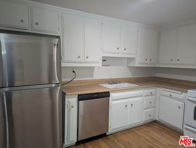 a kitchen with appliances cabinets and a counter top space