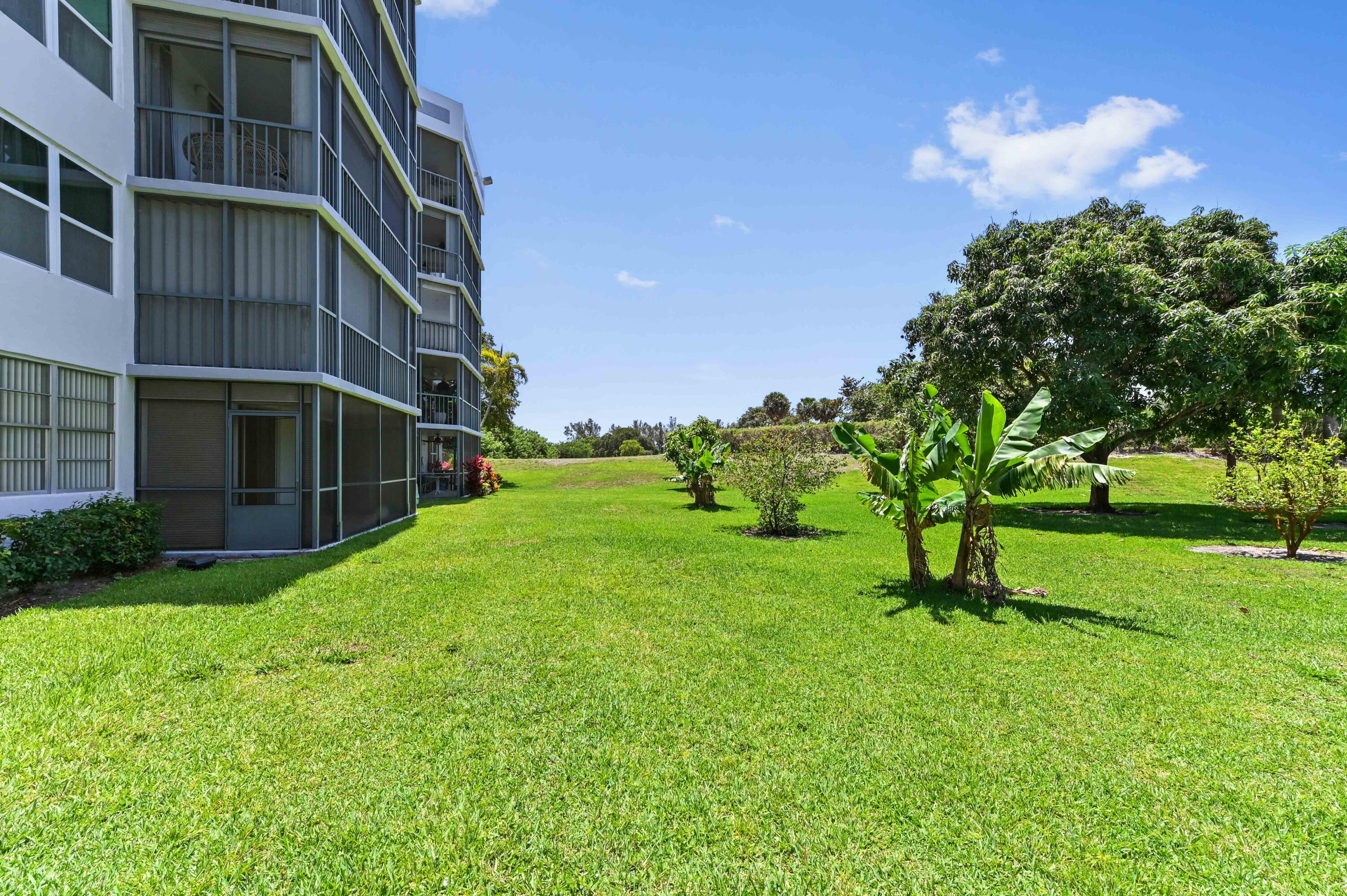198 Northwest 67th Street, Unit 207 Boca Raton, FL 33487 - Photo 36 of 42 a view of a house with a yard