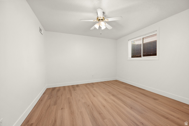 2163 Borg Drive Sandy, UT 84092 - Photo 25 of 31 Empty room with light wood-style floors and ceiling fan