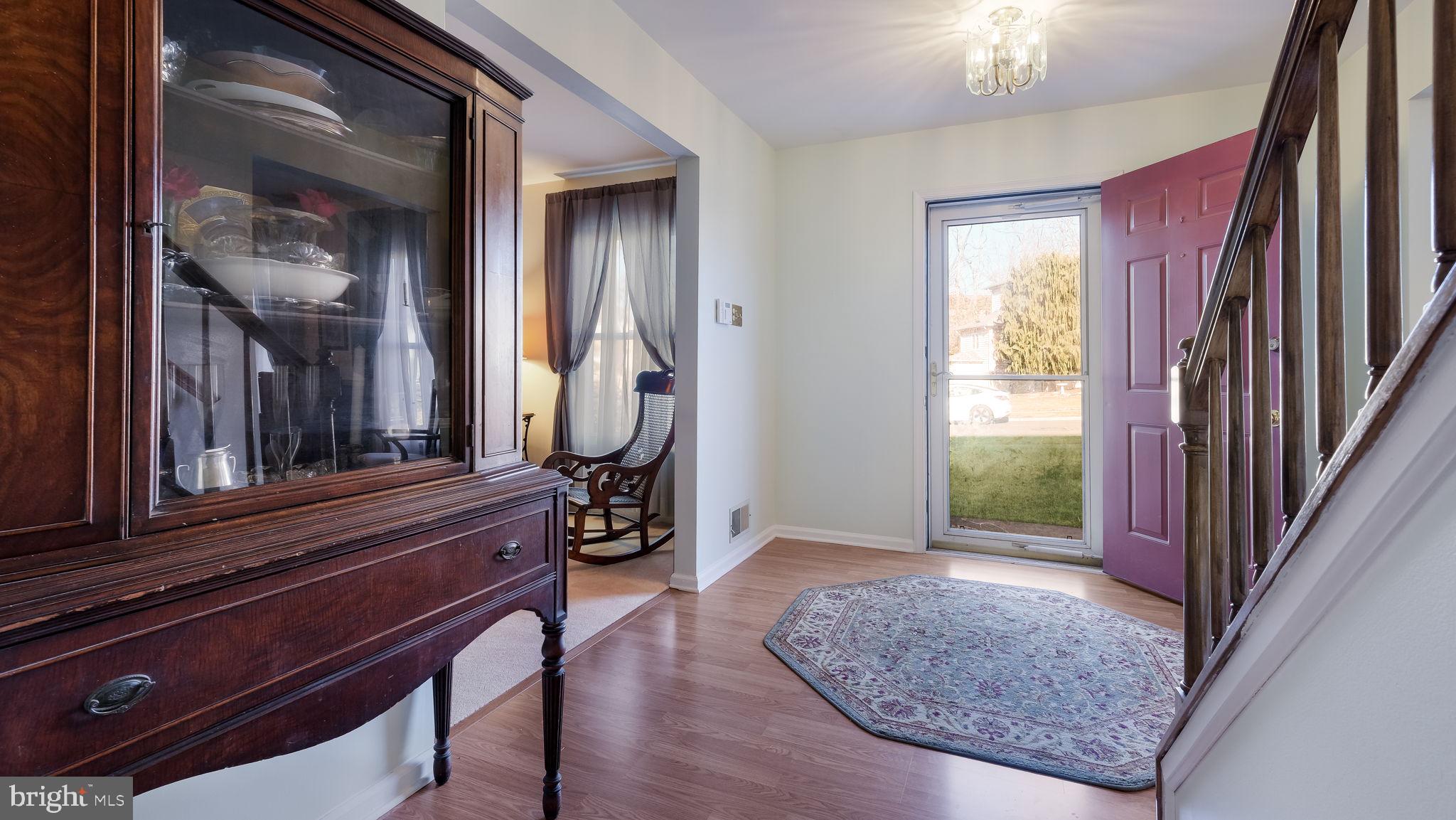 1267 Holly Road Warrington, PA 18976 - Photo 6 of 42 a view of an entryway with wooden floor and a livingroom