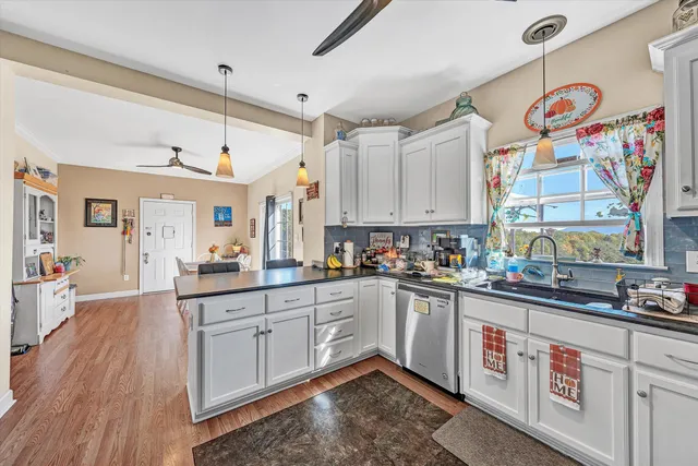a kitchen with stainless steel appliances granite countertop a sink and cabinets