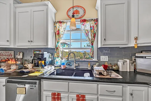 a kitchen with lots of clutter and cabinets