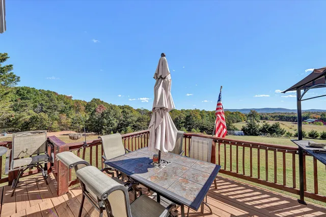 a view of a wooden chairs and table in the balcony