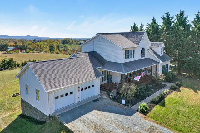 a aerial view of a house with a yard and balcony