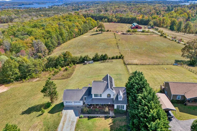 an aerial view of a house with a lake view