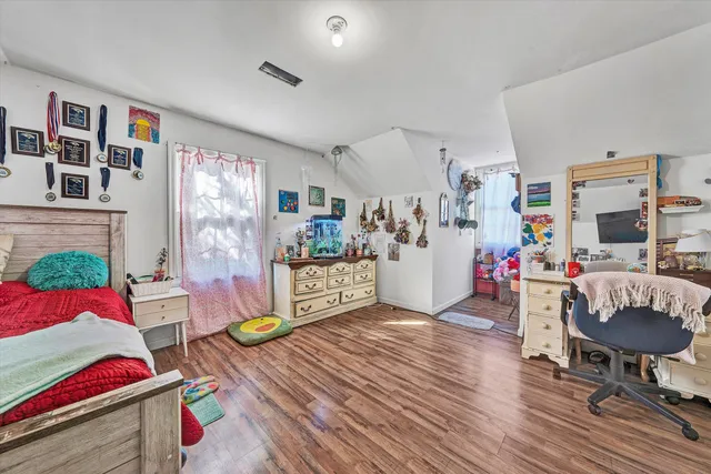 a bedroom with furniture and a flat screen tv