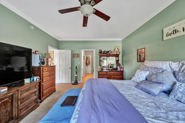 a view of a hallway to a livingroom and a livingroom with furniture