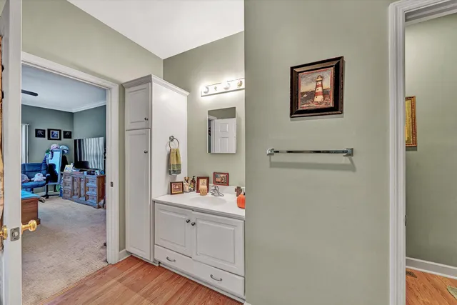 a bathroom with a sink vanity granite tub and shower