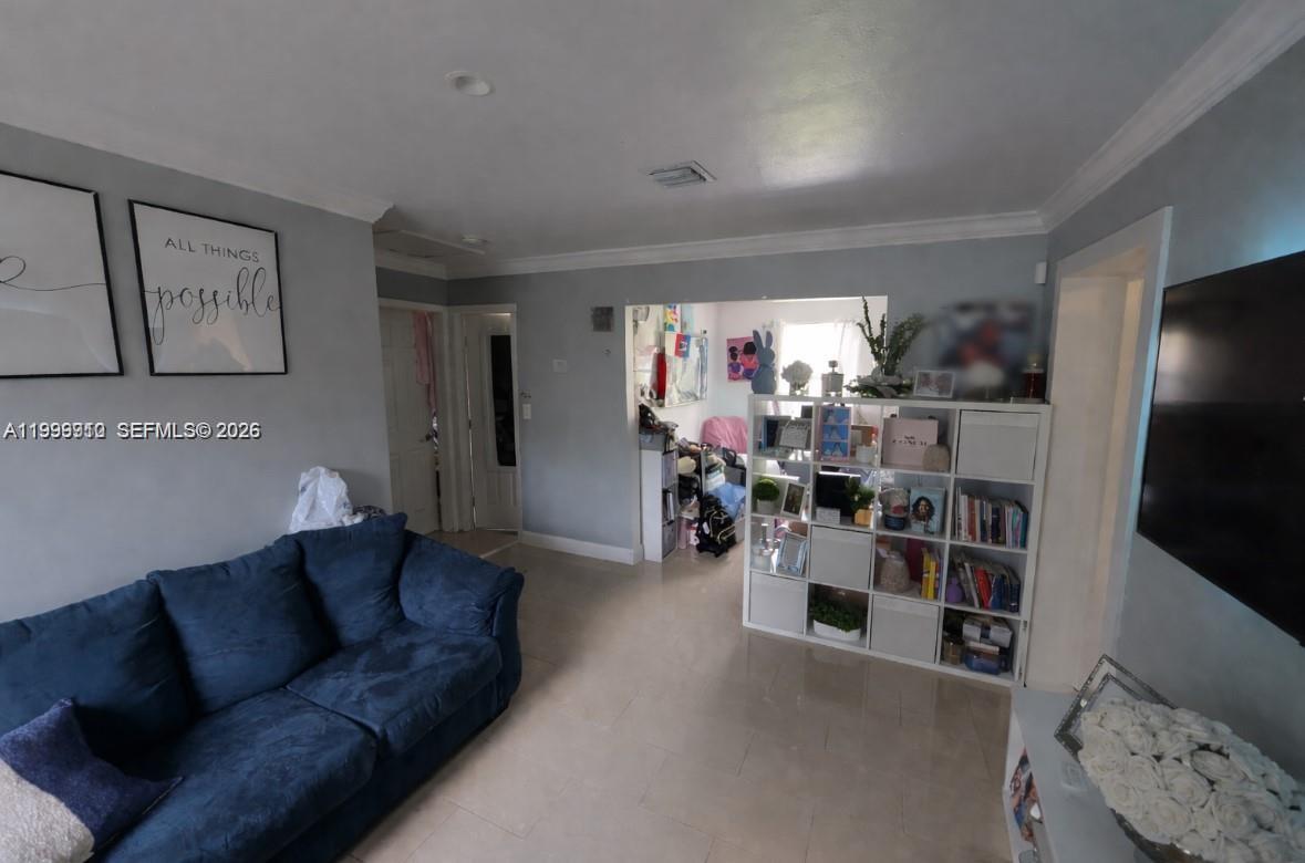 442 Northeast 162nd Street Miami, FL 33162 - Photo 2 of 9 a living room with furniture and a flat screen tv