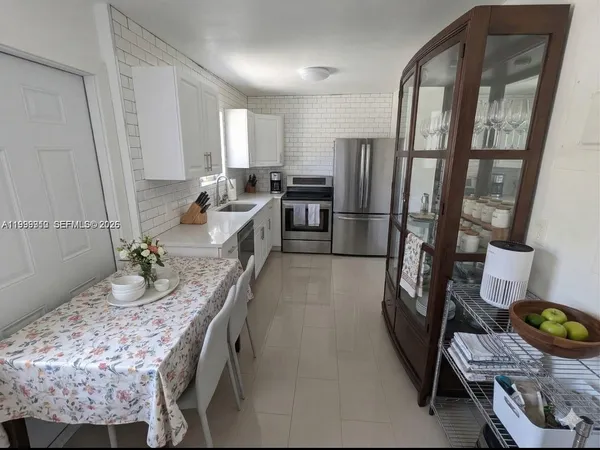 a kitchen with sink refrigerator and stove