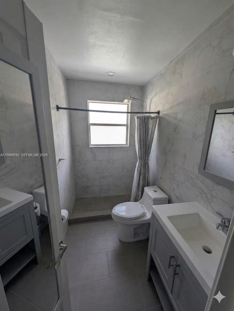 442 Northeast 162nd Street Miami, FL 33162 - Photo 7 of 9 a bathroom with a sink toilet and shower
