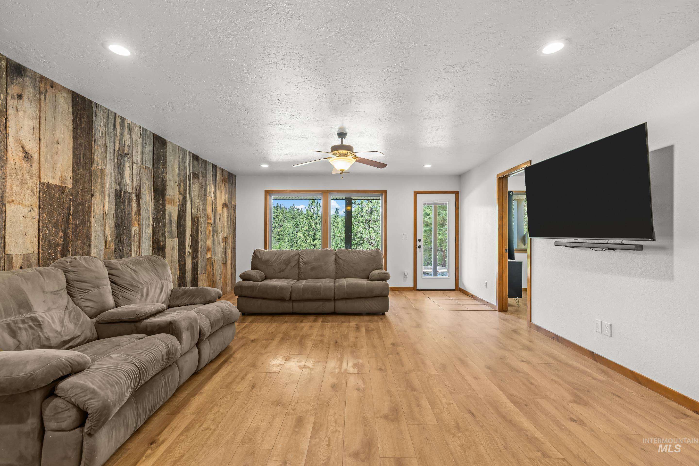 92 Cruickshank Road Horseshoe Bend, ID 83629 - Photo 30 of 50 Spacious interior featuring wood-finish flooring and a distinctive wood panel accent wall