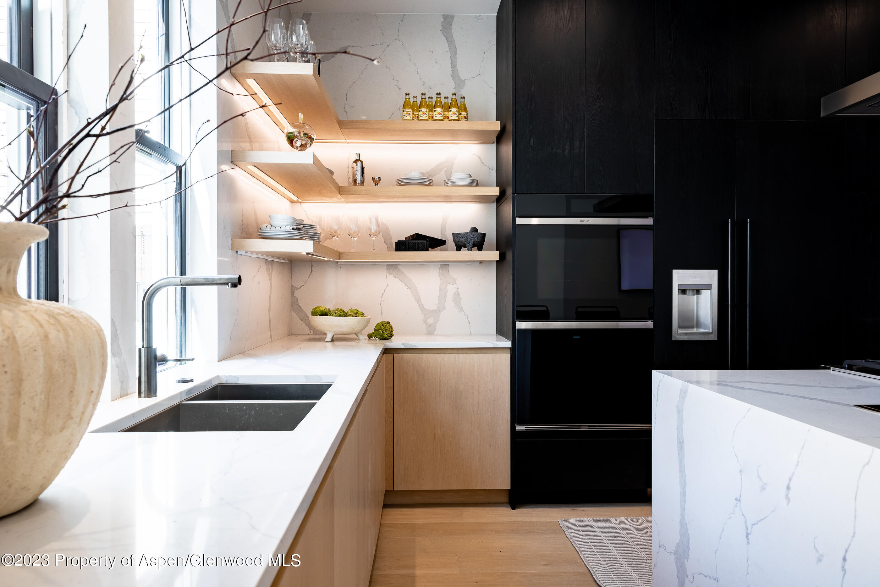 125 West Main Street Aspen, CO 81611 - Photo 11 of 52 a kitchen with a sink and a refrigerator