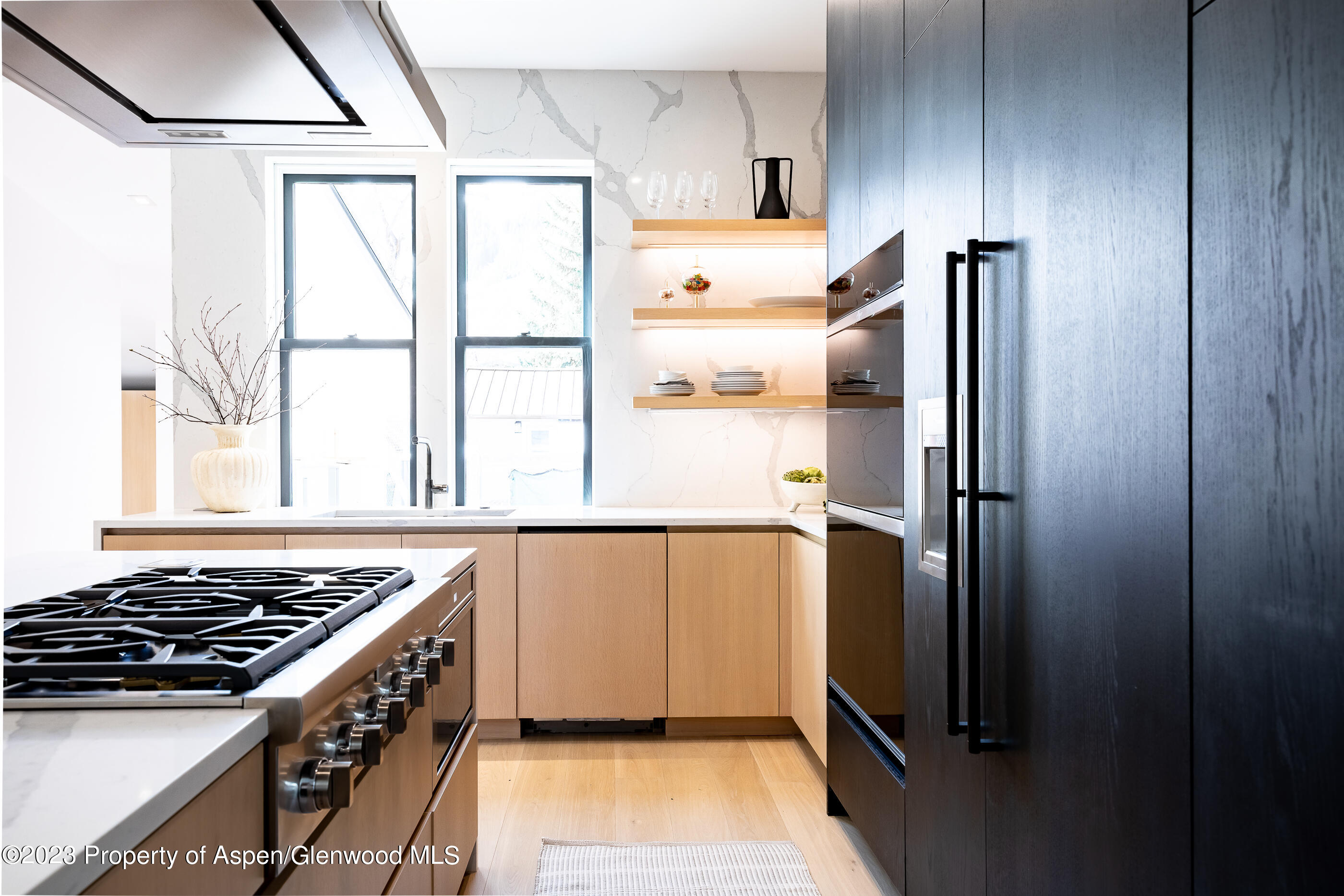 125 West Main Street Aspen, CO 81611 - Photo 12 of 52 a kitchen with a stove a refrigerator and a window
