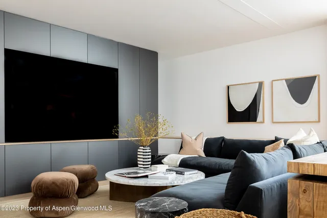 a living room with furniture and a mirror