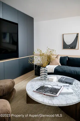 a kitchen with a table chairs and a refrigerator