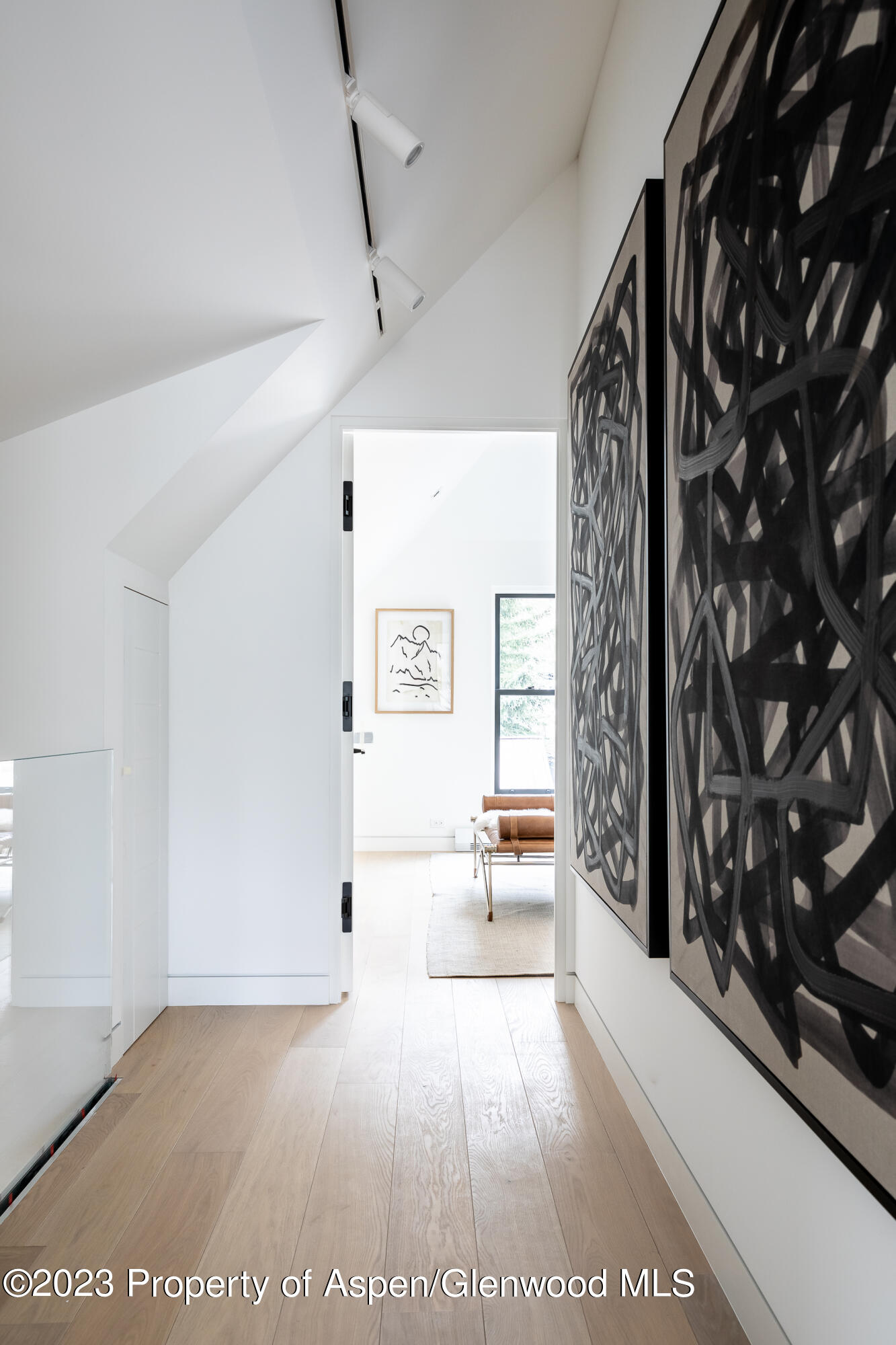 125 West Main Street Aspen, CO 81611 - Photo 21 of 52 a view of a hallway with wooden floor and furniture
