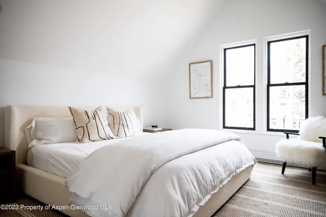 a room with a bed and a flat screen tv