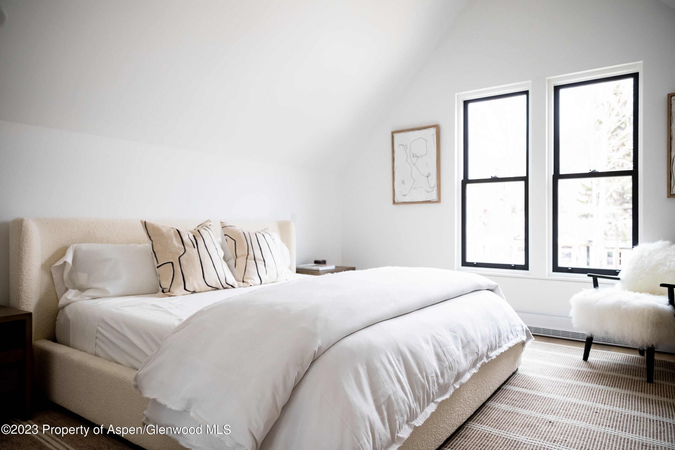 125 West Main Street Aspen, CO 81611 - Photo 23 of 52 a bedroom with a bed and a large window
