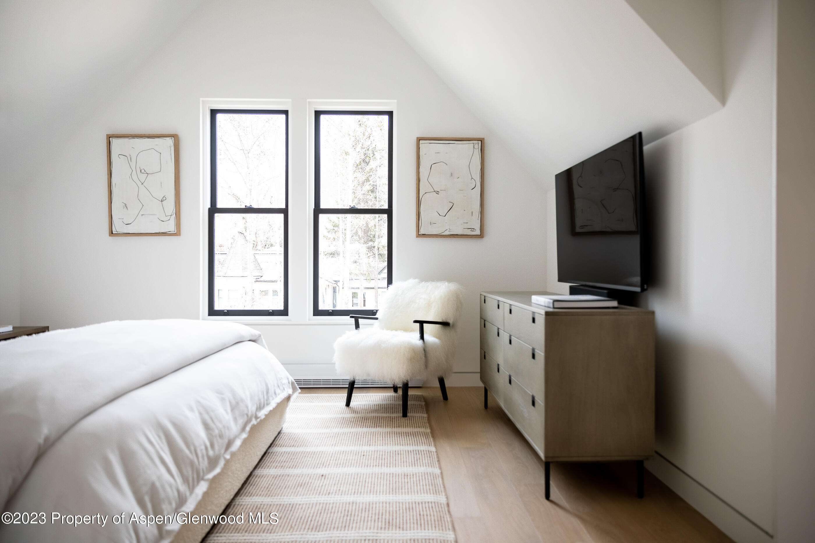 125 West Main Street Aspen, CO 81611 - Photo 24 of 52 a room with a bed and a flat screen tv