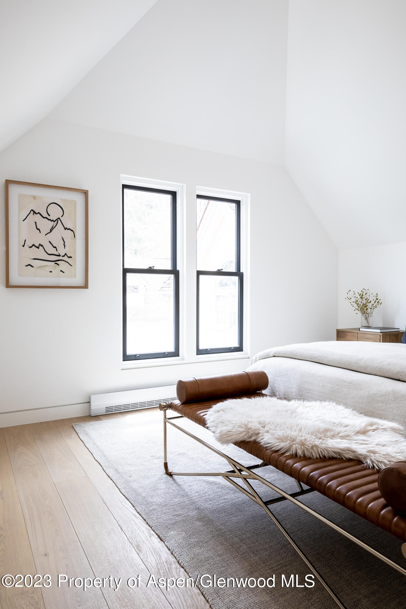 125 West Main Street Aspen, CO 81611 - Photo 28 of 52 a bedroom with a bed and a large window
