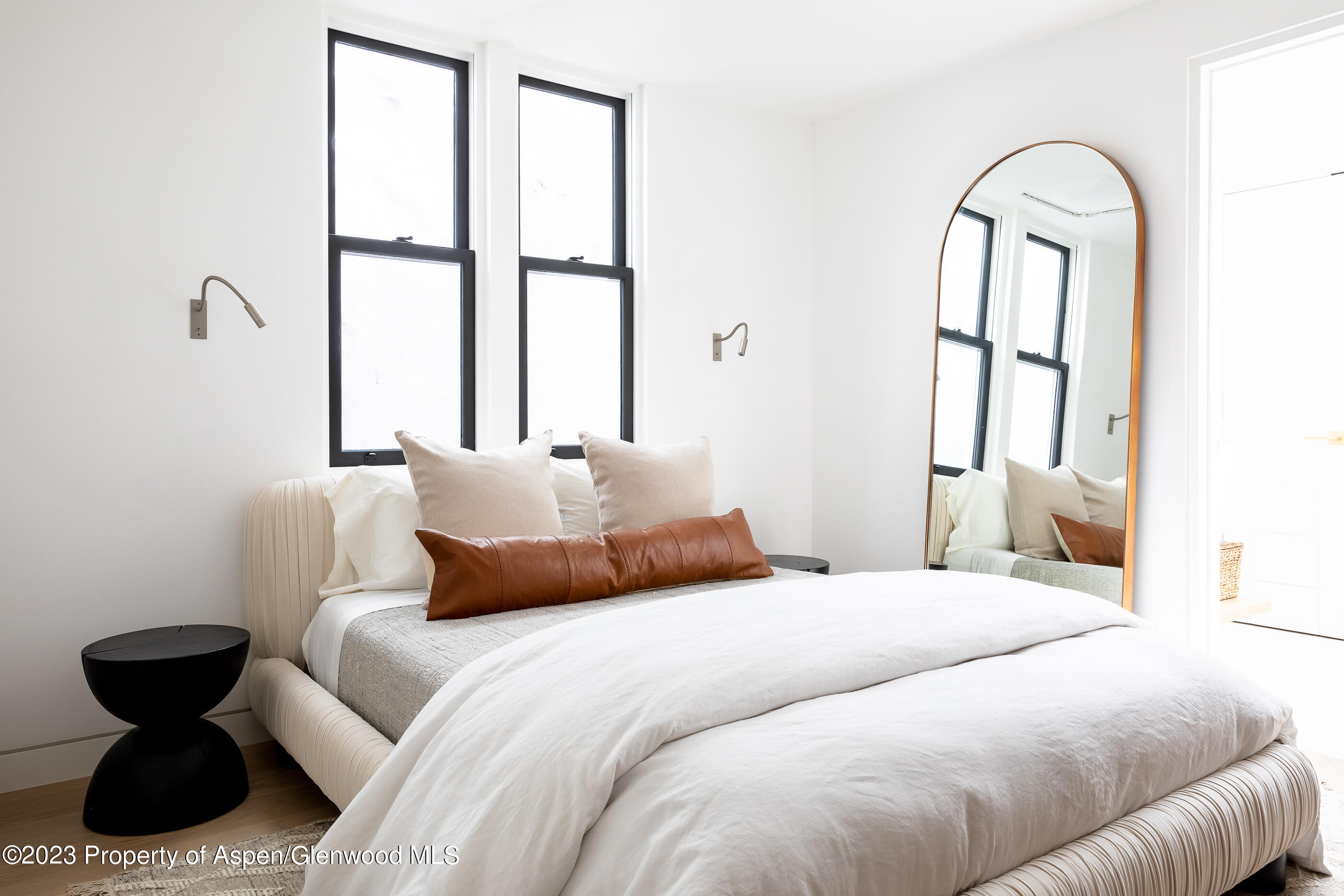 125 West Main Street Aspen, CO 81611 - Photo 32 of 52 a bedroom with a bed and a large window