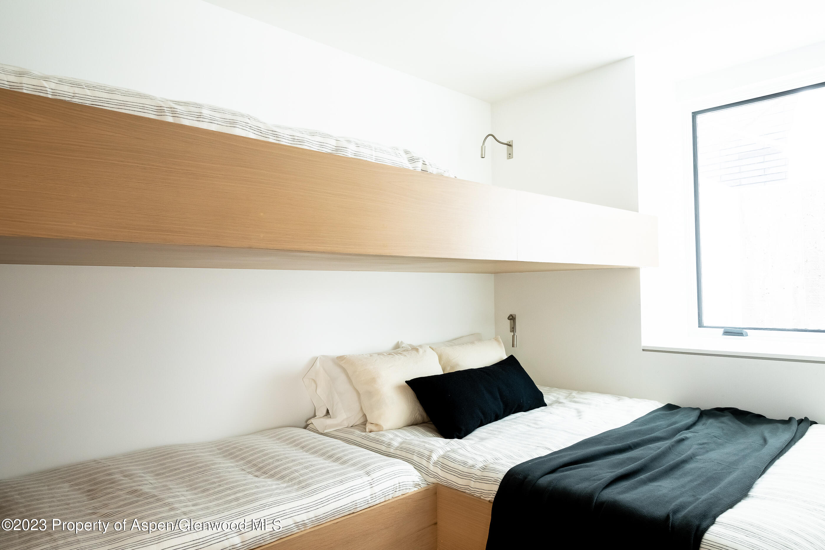 125 West Main Street Aspen, CO 81611 - Photo 42 of 52 a bedroom with a bed and a window