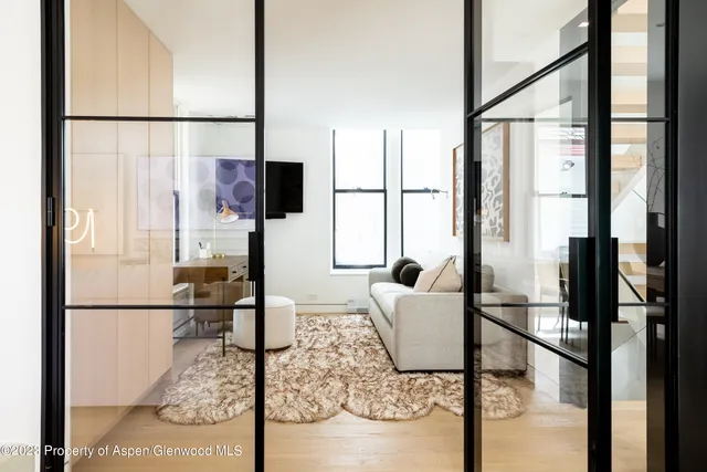 a living room with couches a coffee table and next to a window