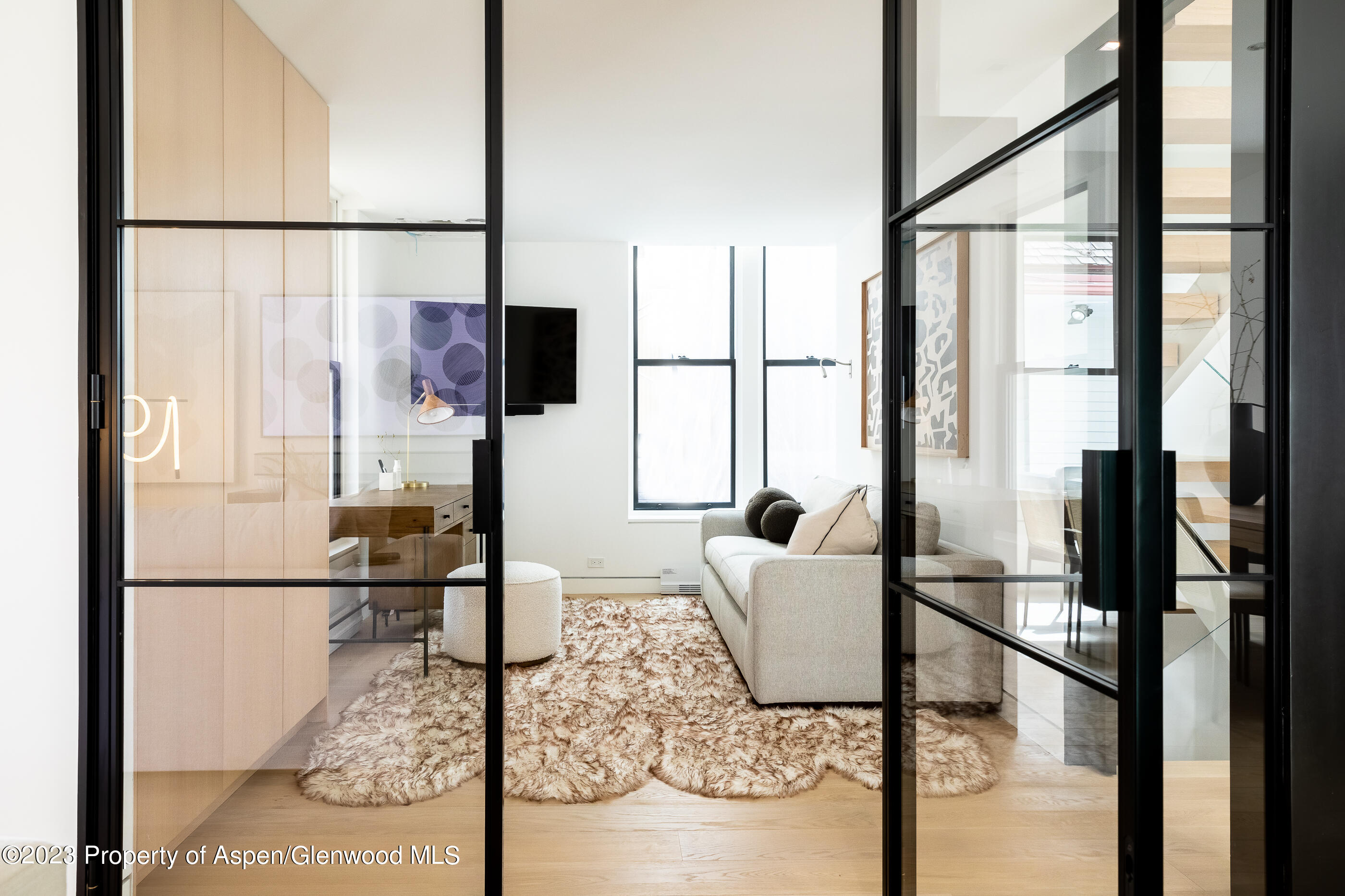 125 West Main Street Aspen, CO 81611 - Photo 6 of 52 a living room with couches a coffee table and next to a window