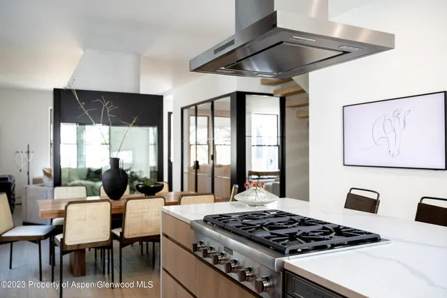 a table and chairs in a kitchen next to a window