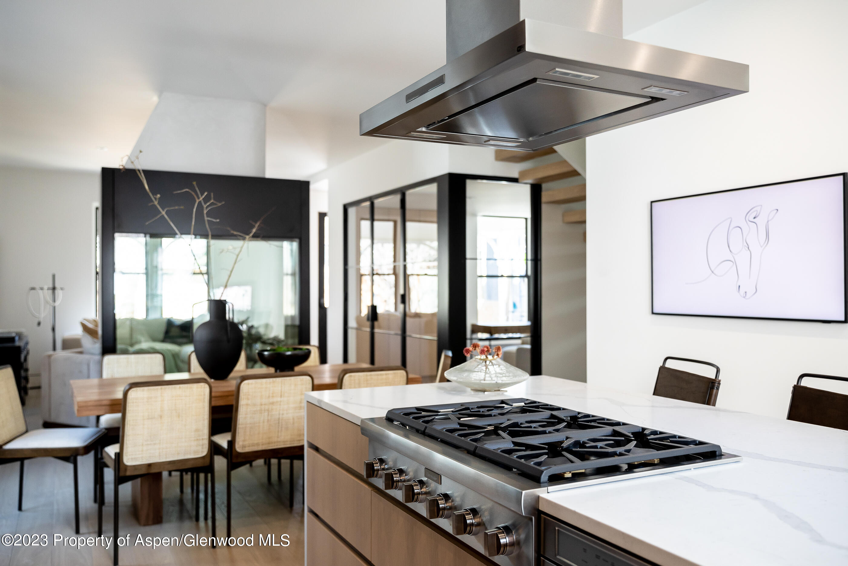 125 West Main Street Aspen, CO 81611 - Photo 9 of 52 a table and chairs in a kitchen next to a window