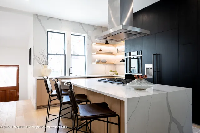 a kitchen with a table chairs and a refrigerator