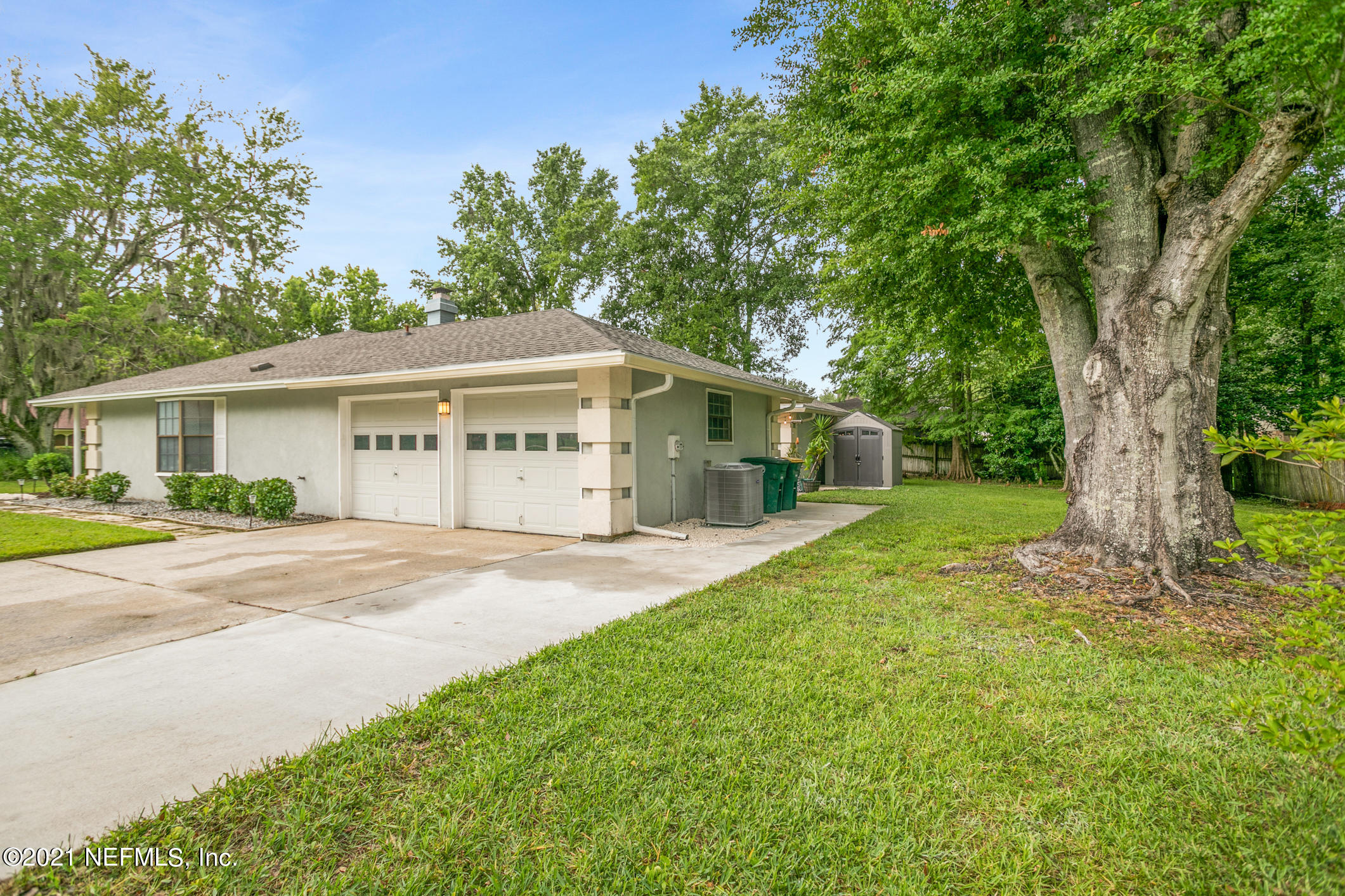 11705 Edinburgh Way Jacksonville, FL 32223 - Photo 19 of 33 a view of a house with a yard and large tree
