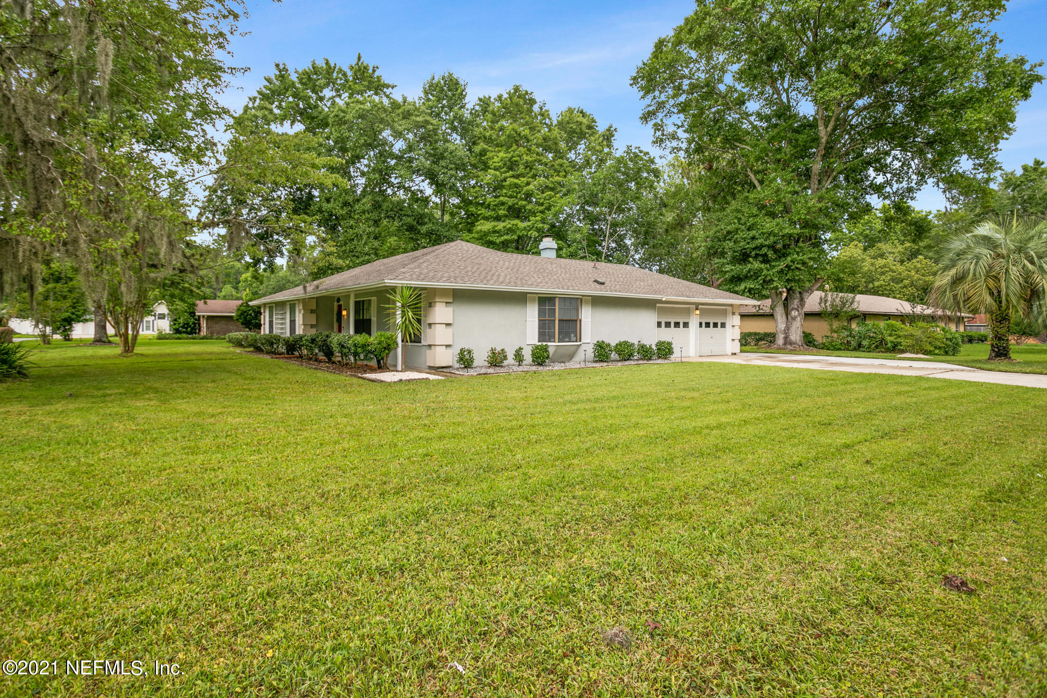 11705 Edinburgh Way Jacksonville, FL 32223 - Photo 26 of 33 a white house with a big yard and large trees