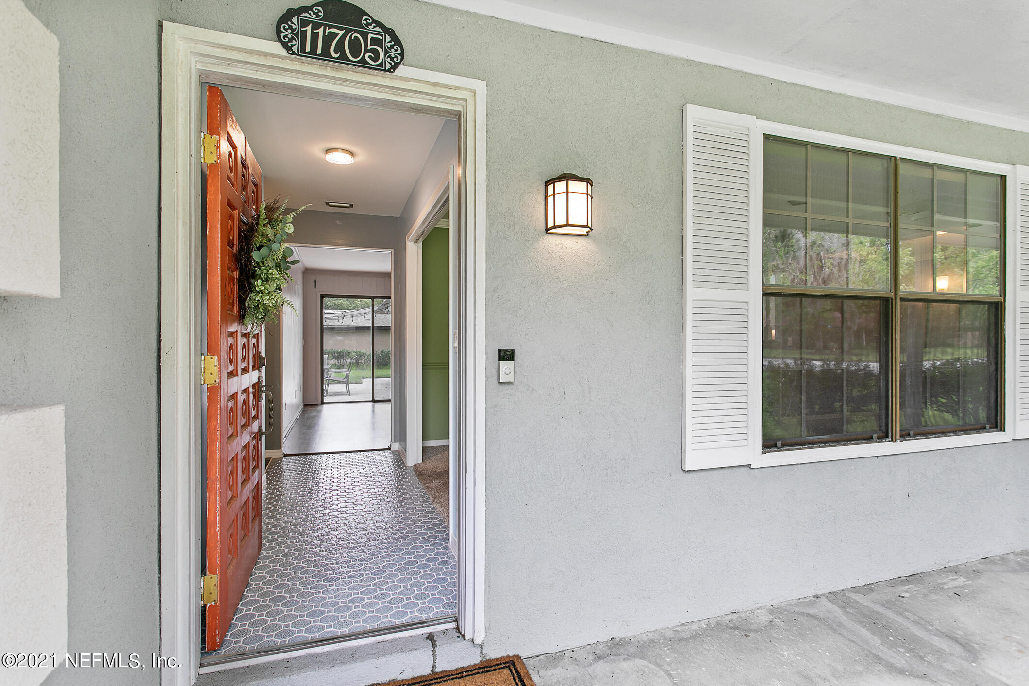 11705 Edinburgh Way Jacksonville, FL 32223 - Photo 6 of 33 a view of a hallway view with wooden floor and a fireplace