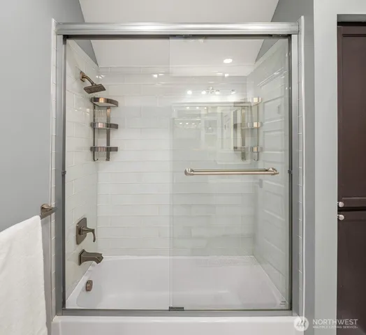a bathroom with a glass shower door