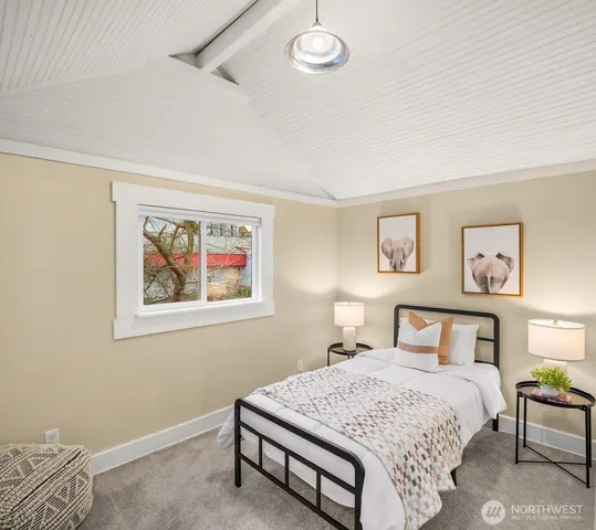 a bedroom with a bed and a painting on the wall