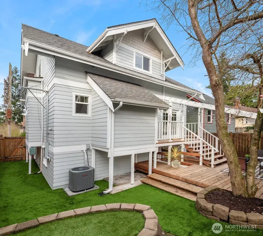 a front view of a house with a yard porch and wooden fence