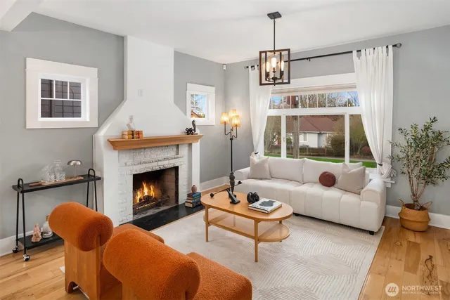 a living room with furniture a window and a fireplace