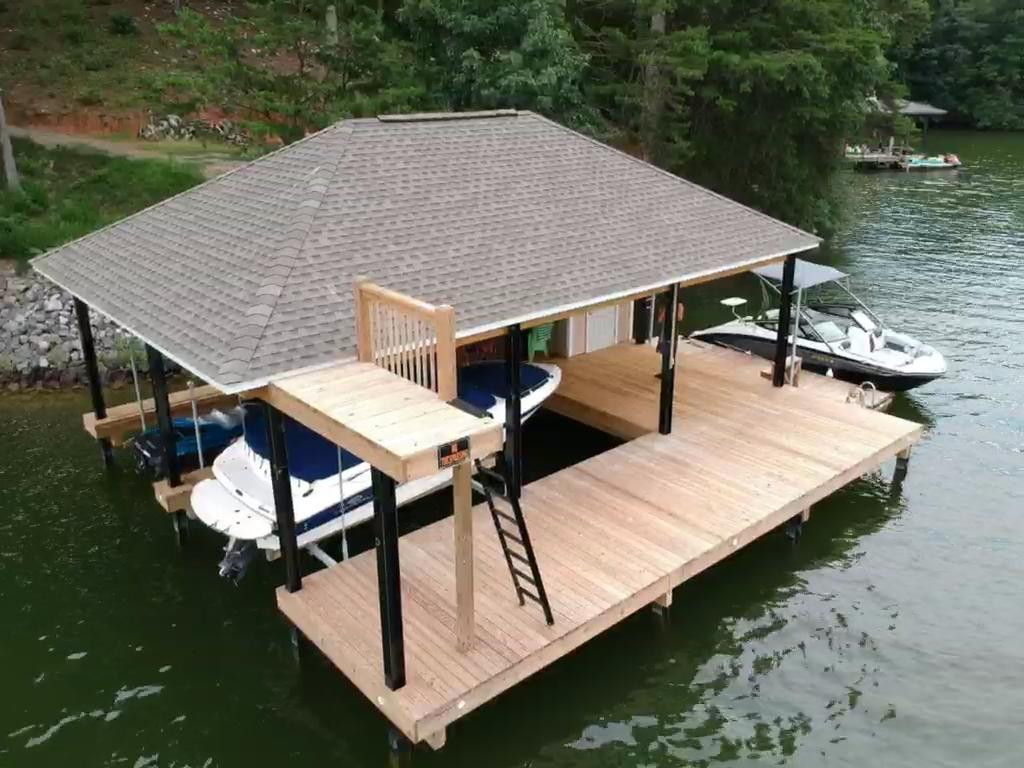6331 Horseshoe Bend Road Goodview, VA 24095 - Photo 13 of 75 a view of a roof deck with table and chairs with wooden floor and fence