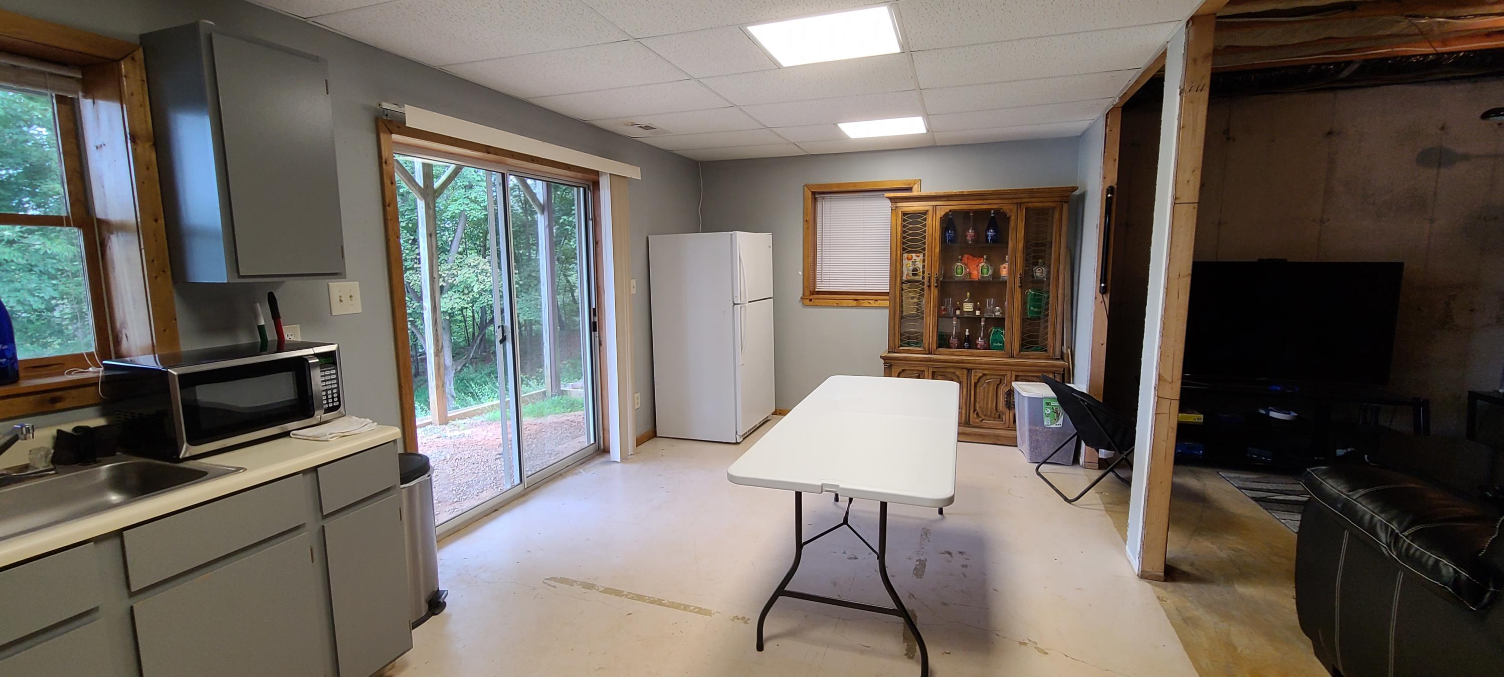 6331 Horseshoe Bend Road Goodview, VA 24095 - Photo 24 of 75 a living room with furniture a flat screen tv and a fireplace