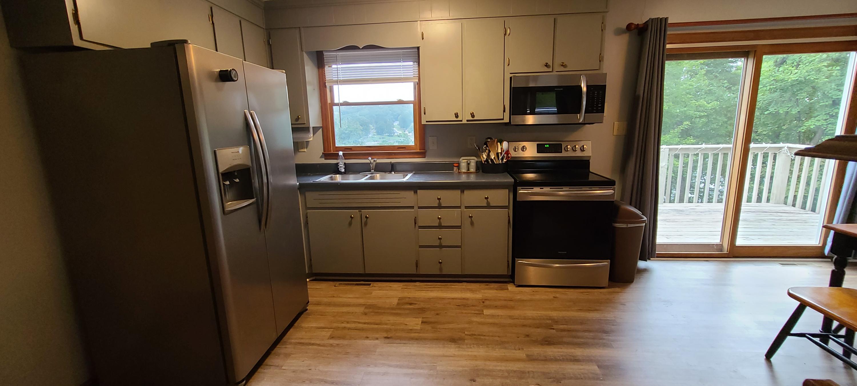 6331 Horseshoe Bend Road Goodview, VA 24095 - Photo 46 of 75 a kitchen with stainless steel appliances granite countertop a refrigerator a stove a sink and a microwave