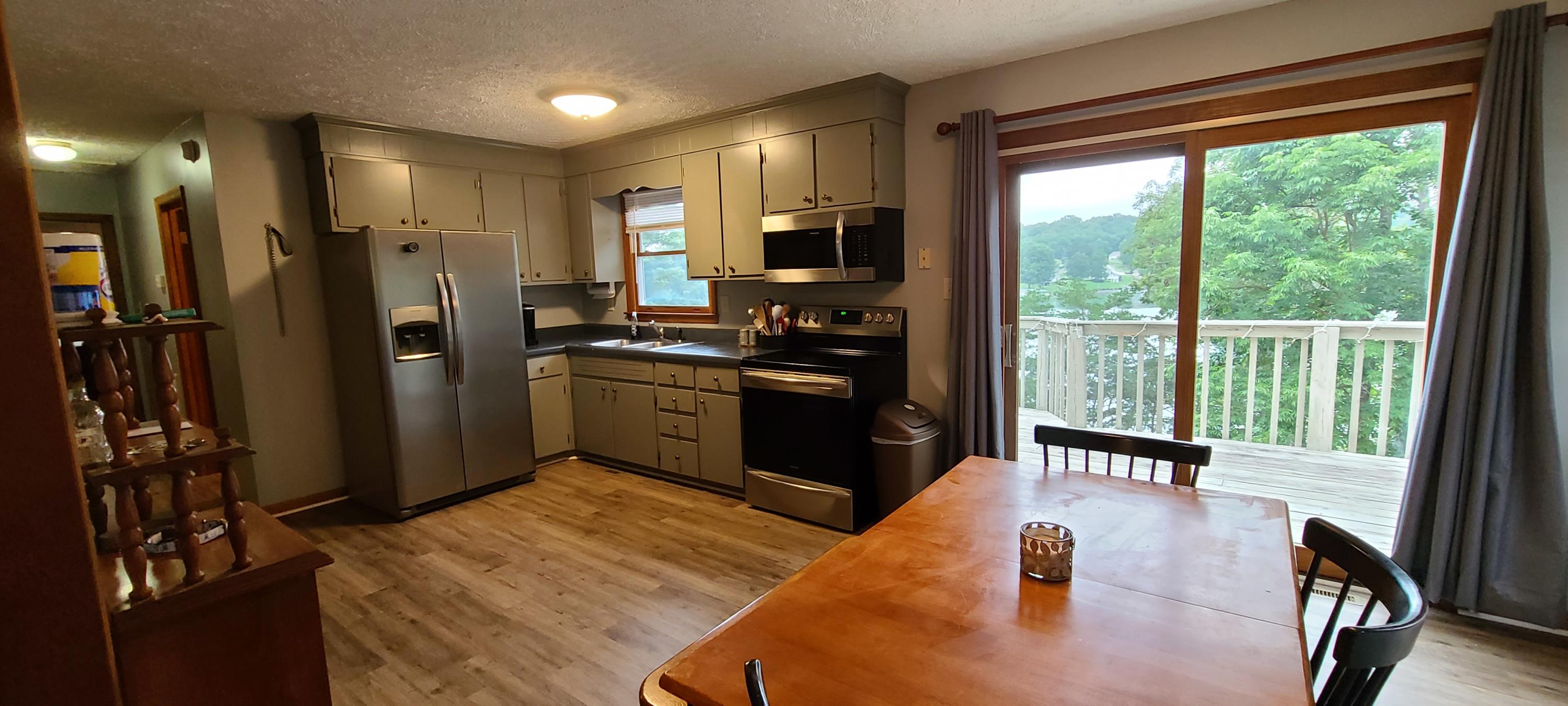 6331 Horseshoe Bend Road Goodview, VA 24095 - Photo 49 of 75 a kitchen with stainless steel appliances granite countertop sink refrigerator and stove
