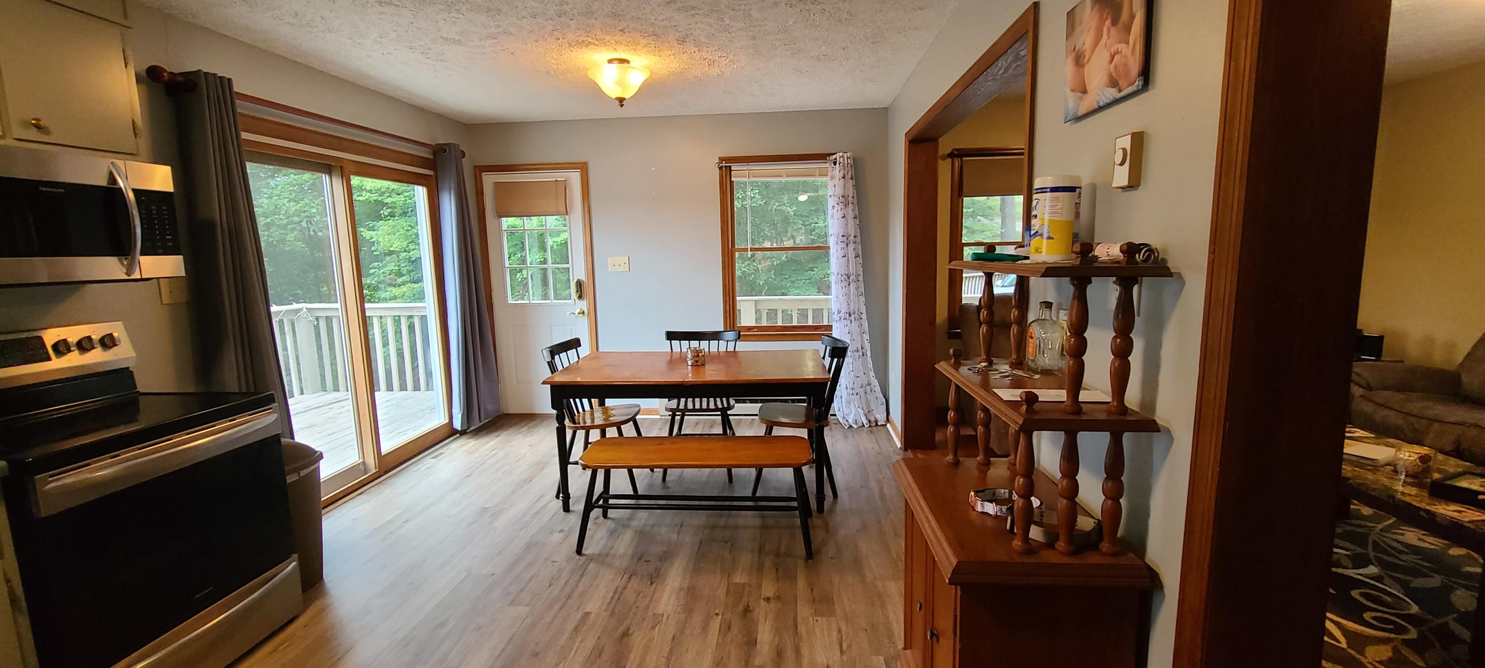 6331 Horseshoe Bend Road Goodview, VA 24095 - Photo 52 of 75 a dining room with furniture and wooden floor